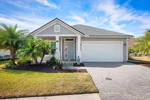 view of front of house featuring a garage and a front lawn