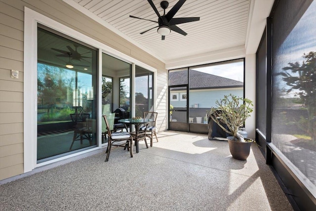 sunroom with wood ceiling and ceiling fan