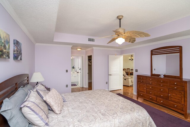 bedroom with ceiling fan, a closet, a spacious closet, and ornamental molding