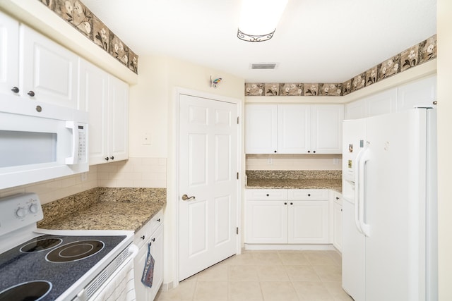 kitchen with decorative backsplash, white cabinets, dark stone counters, and white appliances