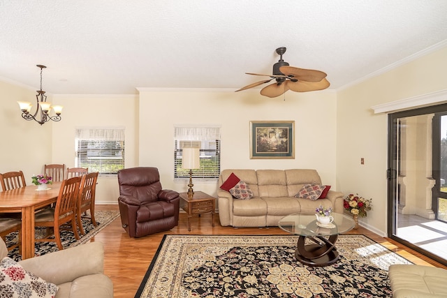 living room featuring light hardwood / wood-style floors, plenty of natural light, and crown molding