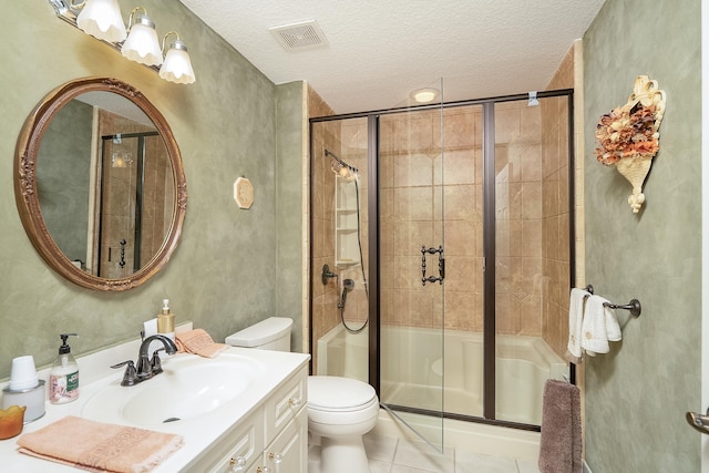 bathroom with tile patterned flooring, toilet, a textured ceiling, and walk in shower