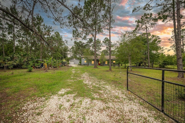 4405 Alvin St, Hastings, FL 32145 - view of yard with a garage, view of scattered trees, and a gate