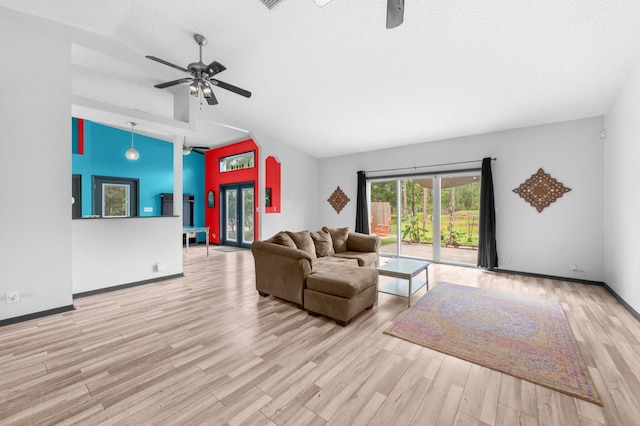 4405 Alvin St, Hastings, FL 32145 - living room featuring a ceiling fan, vaulted ceiling, wood finished floors, baseboards, and a textured ceiling