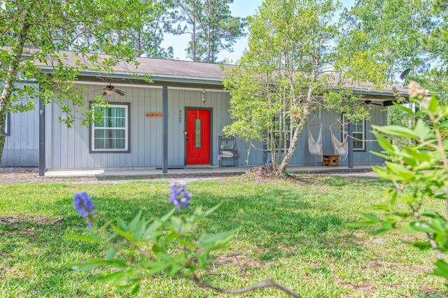 4405 Alvin St, Hastings, FL 32145 - view of front of property with a porch, a ceiling fan, a front lawn, and board and batten siding