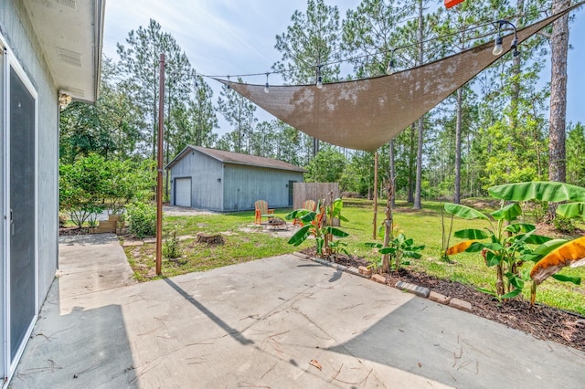 4405 Alvin St, Hastings, FL 32145 - view of patio / terrace featuring a detached garage, an outdoor fire pit, and an outbuilding