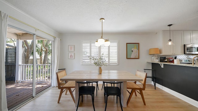 108 A St Unit A, Saint Augustine, FL 32080 - dining room with light wood-type flooring and a textured ceiling