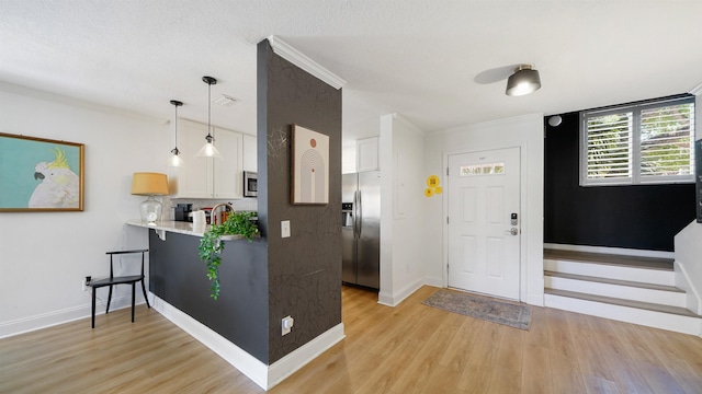 108 A St Unit A, Saint Augustine, FL 32080 - entryway featuring light wood-type flooring and crown molding
