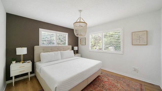 108 A St Unit A, Saint Augustine, FL 32080 - bedroom featuring wood finished floors and a chandelier