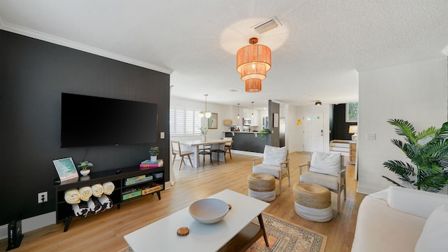 108 A St Unit A, Saint Augustine, FL 32080 - living room with light wood-style flooring and crown molding