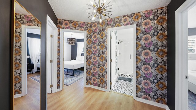 108 A St Unit A, Saint Augustine, FL 32080 - entrance foyer featuring wood finished floors, a chandelier, and wallpapered walls