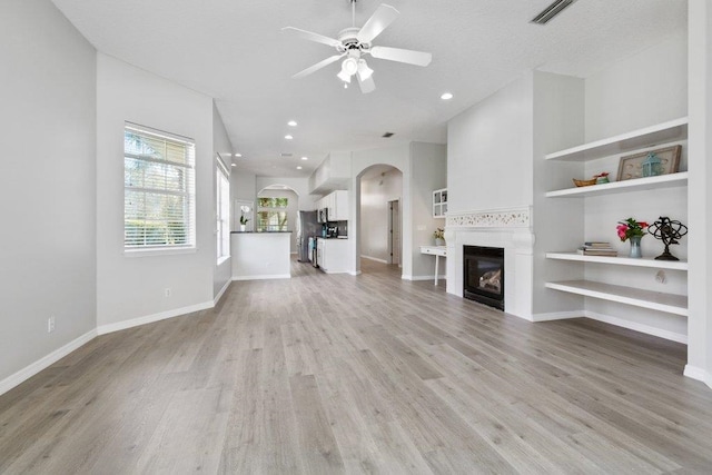 unfurnished living room featuring light hardwood / wood-style flooring and ceiling fan