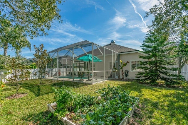 rear view of house with a swimming pool, a lawn, and a lanai