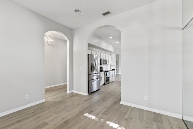 unfurnished living room with light wood-type flooring