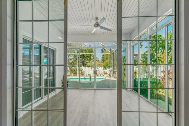 doorway with ceiling fan