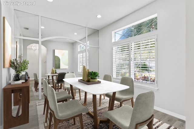 dining area with a healthy amount of sunlight and light hardwood / wood-style floors