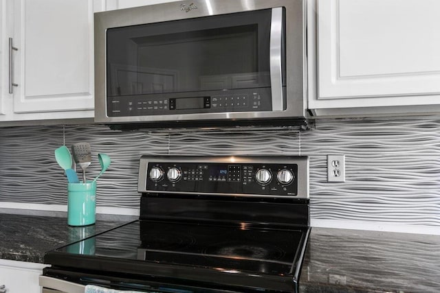 room details with white cabinetry and black range with electric cooktop