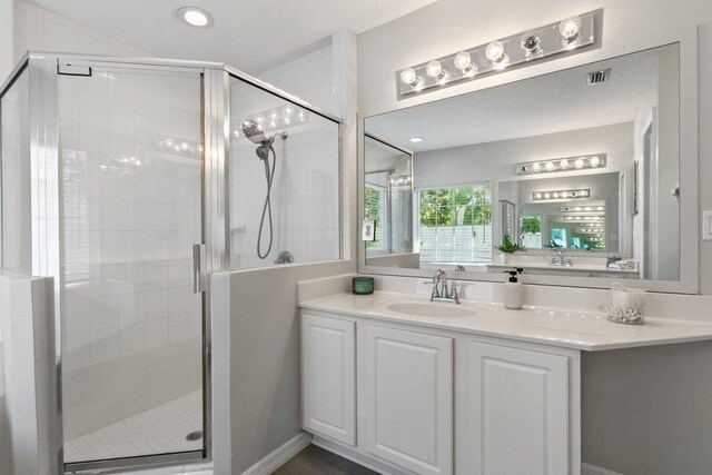 bathroom featuring a relaxing tiled tub and plenty of natural light