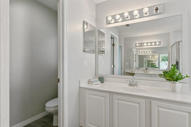 bathroom featuring vanity and toilet