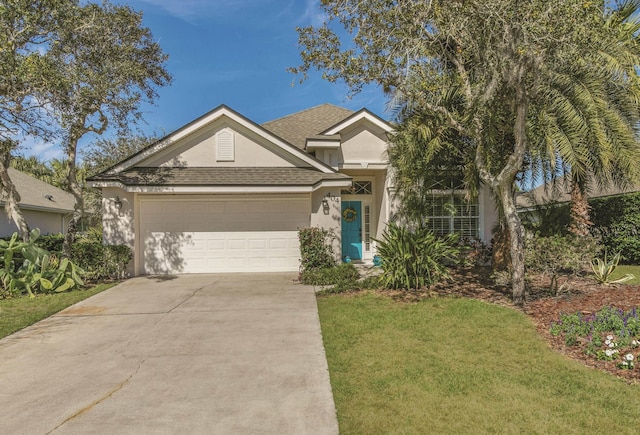 view of front of house with a garage and a front lawn