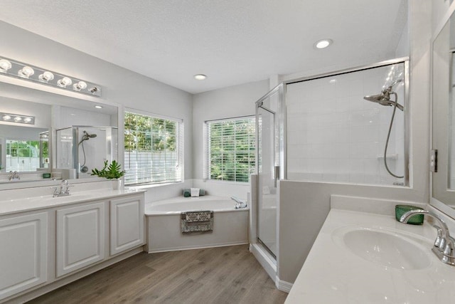 bathroom with vanity, separate shower and tub, and hardwood / wood-style floors