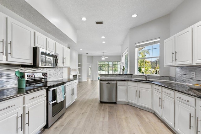 kitchen with white cabinetry, sink, decorative backsplash, and appliances with stainless steel finishes