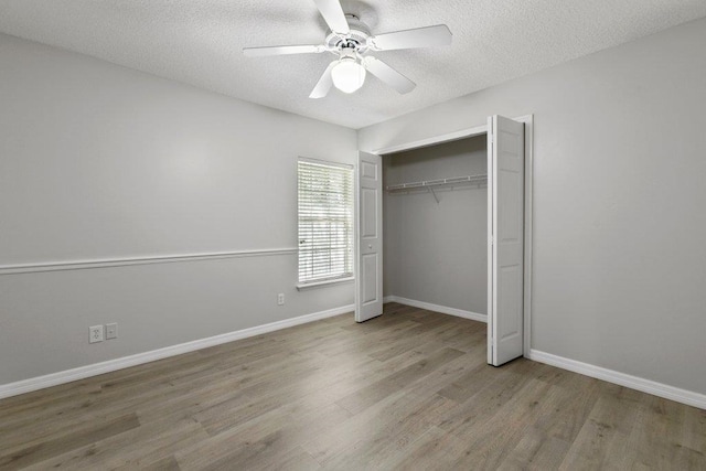 unfurnished bedroom featuring a closet, light hardwood / wood-style flooring, and a textured ceiling