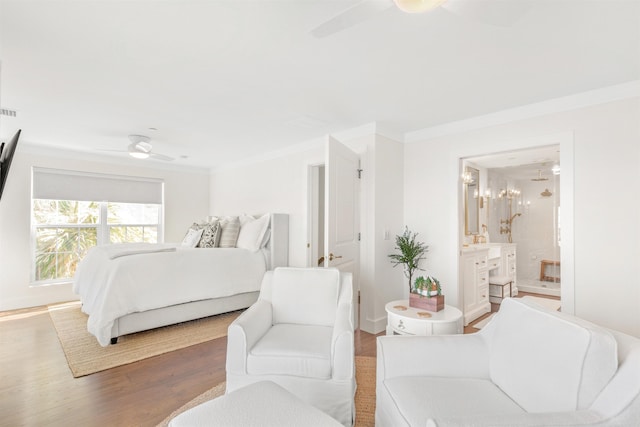 bedroom with hardwood / wood-style flooring, ceiling fan, ornamental molding, and ensuite bathroom