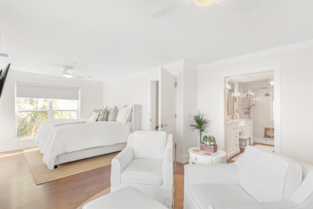 211 2nd St, Saint Augustine, FL 32080 - bedroom with ornamental molding, wood finished floors, ceiling fan, and connected bathroom