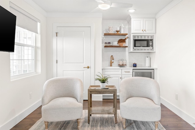 211 2nd St, Saint Augustine, FL 32080 - sitting room with a ceiling fan and dark wood-style floors