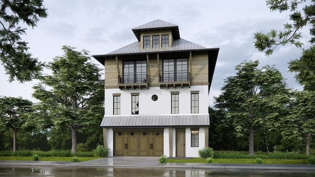211 2nd St, Saint Augustine, FL 32080 - view of front of home featuring a standing seam roof, a metal roof, a balcony, a garage, and stucco siding