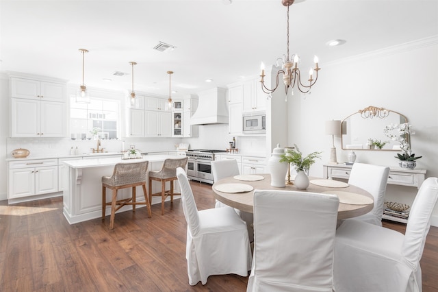 211 2nd St, Saint Augustine, FL 32080 - dining space with a chandelier, ornamental molding, dark wood-style flooring, and recessed lighting