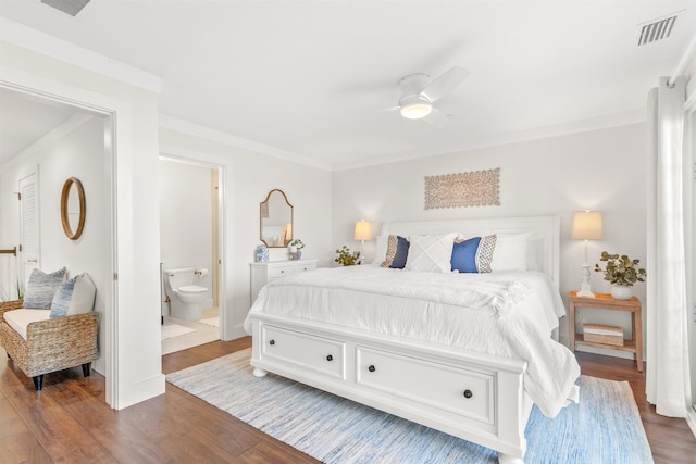 bedroom with dark wood-type flooring, ceiling fan, crown molding, and ensuite bathroom