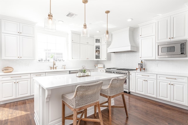 211 2nd St, Saint Augustine, FL 32080 - kitchen featuring appliances with stainless steel finishes, custom exhaust hood, white cabinetry, and recessed lighting