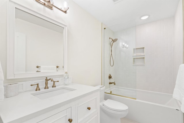 full bathroom featuring vanity, toilet, and tiled shower / bath