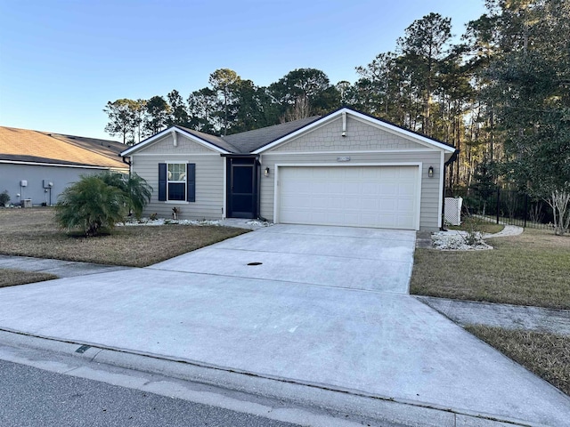 single story home with a garage and a front lawn