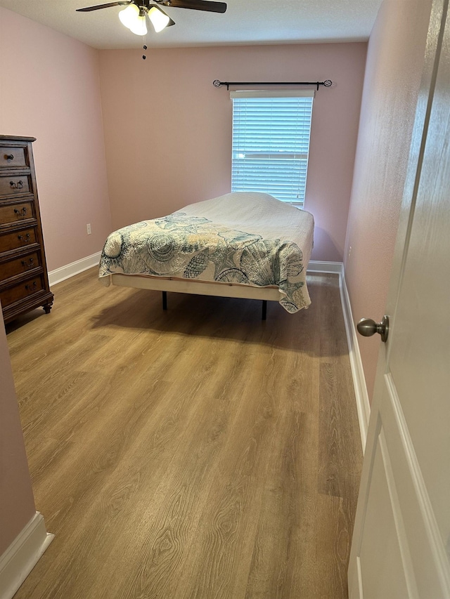 bedroom featuring ceiling fan and wood-type flooring