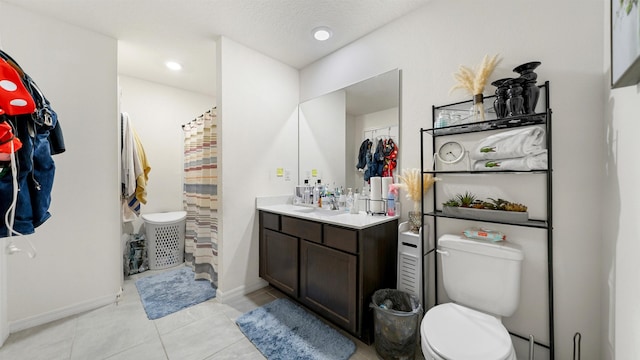 bathroom featuring vanity, a shower with curtain, tile patterned flooring, toilet, and a textured ceiling