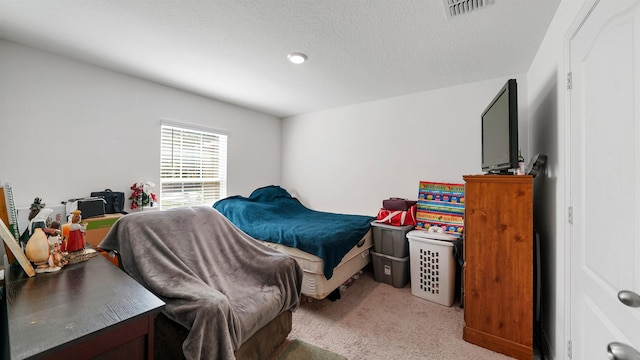 carpeted bedroom with a textured ceiling