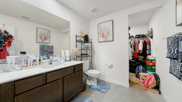 bathroom with tile patterned floors, vanity, and toilet