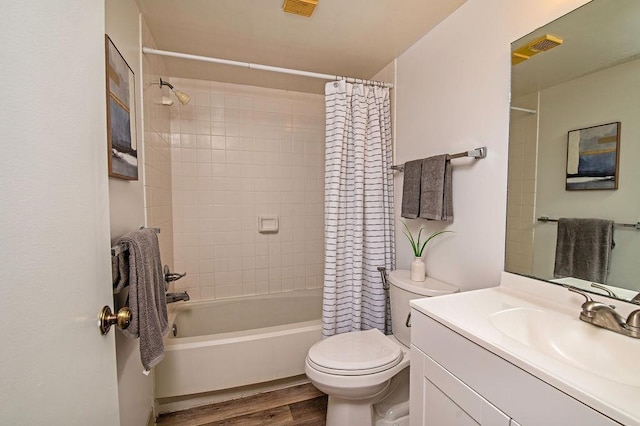 full bathroom with vanity, shower / bathtub combination with curtain, wood-type flooring, and toilet