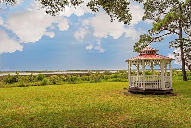 view of property's community with a gazebo and a yard