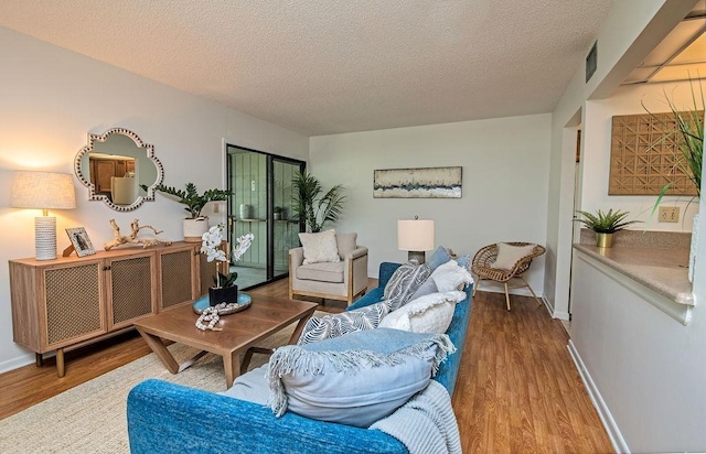 living room featuring hardwood / wood-style floors and a textured ceiling