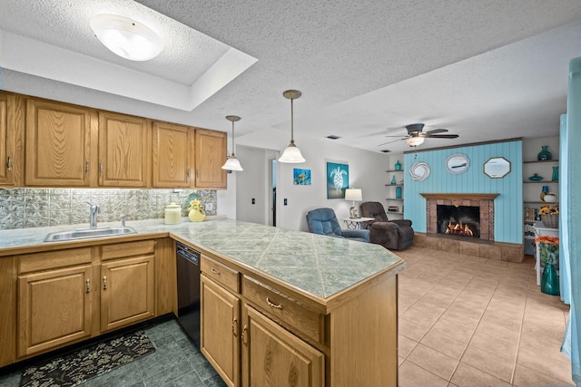 kitchen with kitchen peninsula, a fireplace, dishwasher, and sink