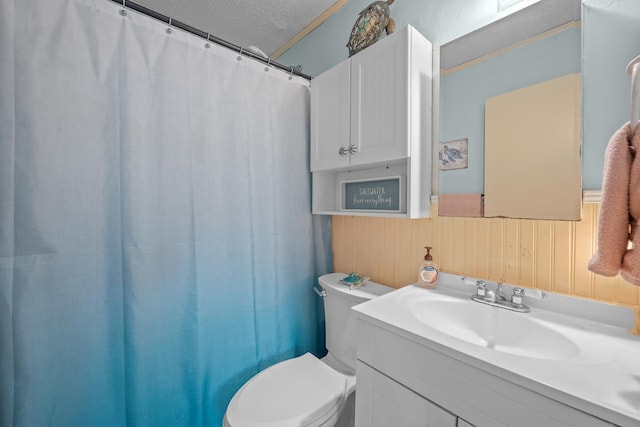 bathroom featuring walk in shower, wood walls, a textured ceiling, toilet, and vanity