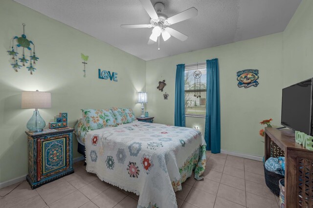 tiled bedroom featuring ceiling fan and a textured ceiling