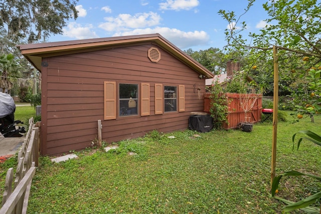 view of side of property with a lawn