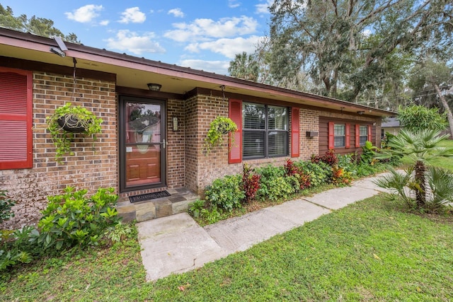 entrance to property with a yard