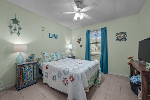 bedroom with light tile patterned floors, a textured ceiling, and ceiling fan