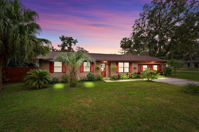 single story home featuring a yard